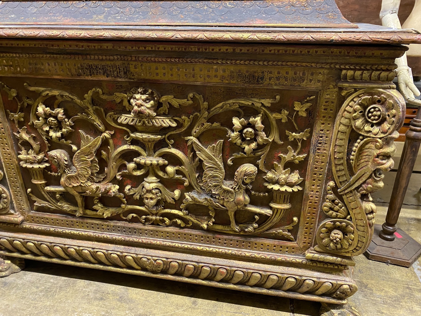 A 17th century style painted gilded cassone on lion's paw feet, length 153cm, depth 66cm, height 118cm